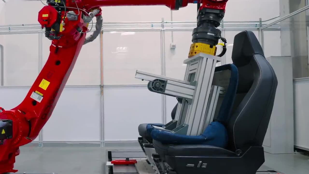 Video thumbnail for Tesla Robot testing seats. They test each seat with 50k ingress and egress cycles which is equivalent to a lifetime of use.
